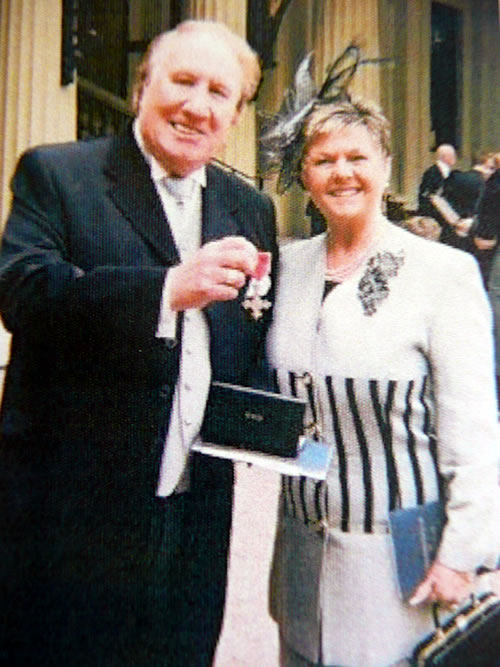 Duggie Chapman with wife Beryl colecting his MBE outside Buckingham Palace.