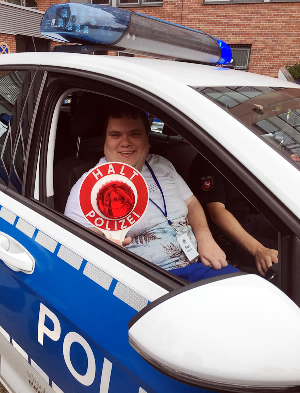 One of our group, Dan Travers, in the all electric VW police car at G�ttingen police station