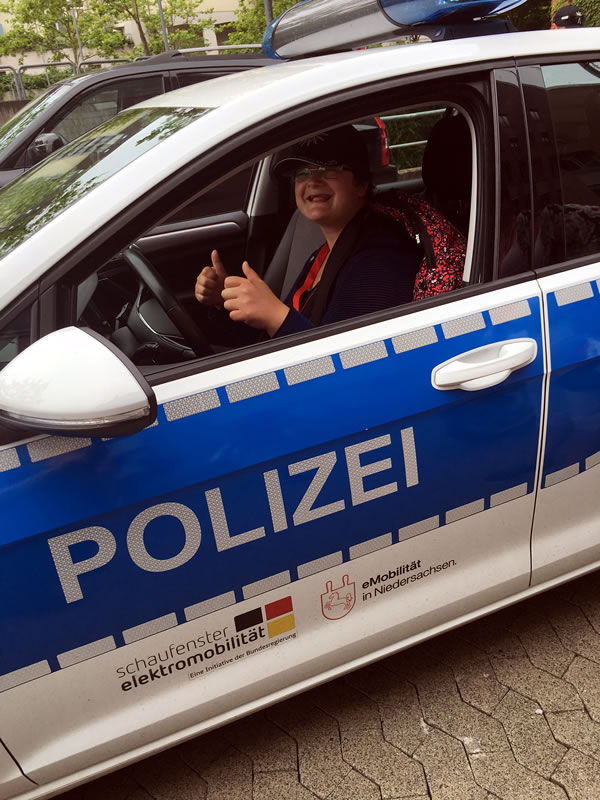 Another of our group, Klaudia Partyka, in the all electric VW police car at G�ttingen police station