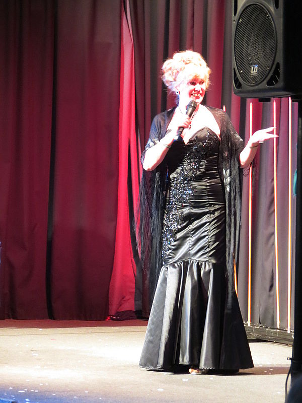 Caroline in black dress on stage